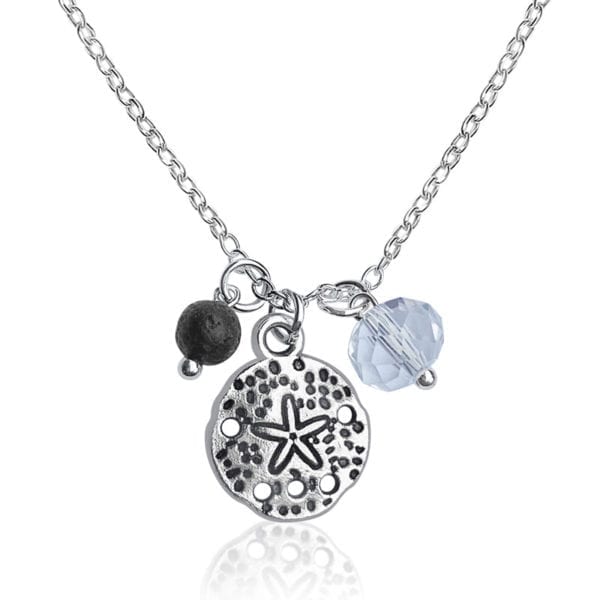 This image portrays Gogh Jewelry Design Sand Dollar Earrings and Necklace with Lava Stone by Scuba Show | June 3 & 4, 2023.